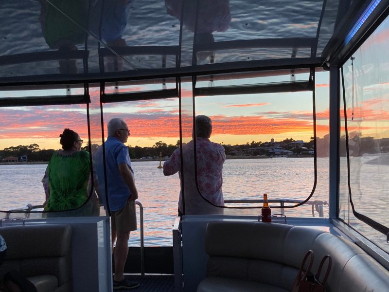 a group of people in a boat on a body of water