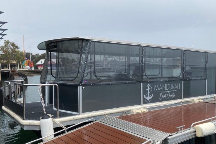 a boat sitting on top of a metal rail
